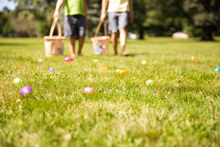 easter eggs hunt. Blurred silhouettes of children with baskets in hands.