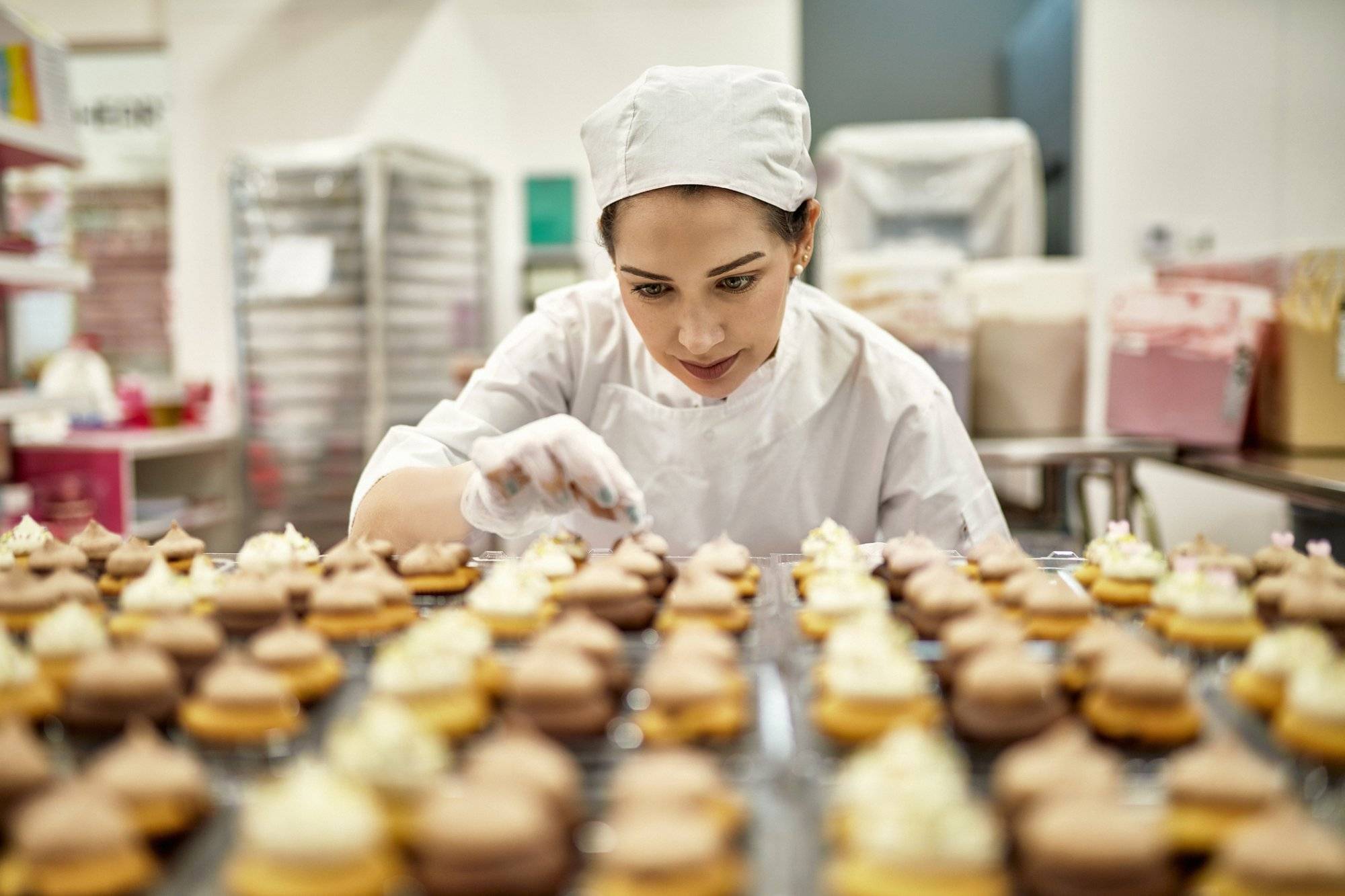 Hispanic American Female Baker Decorating Vegan Cupcakes